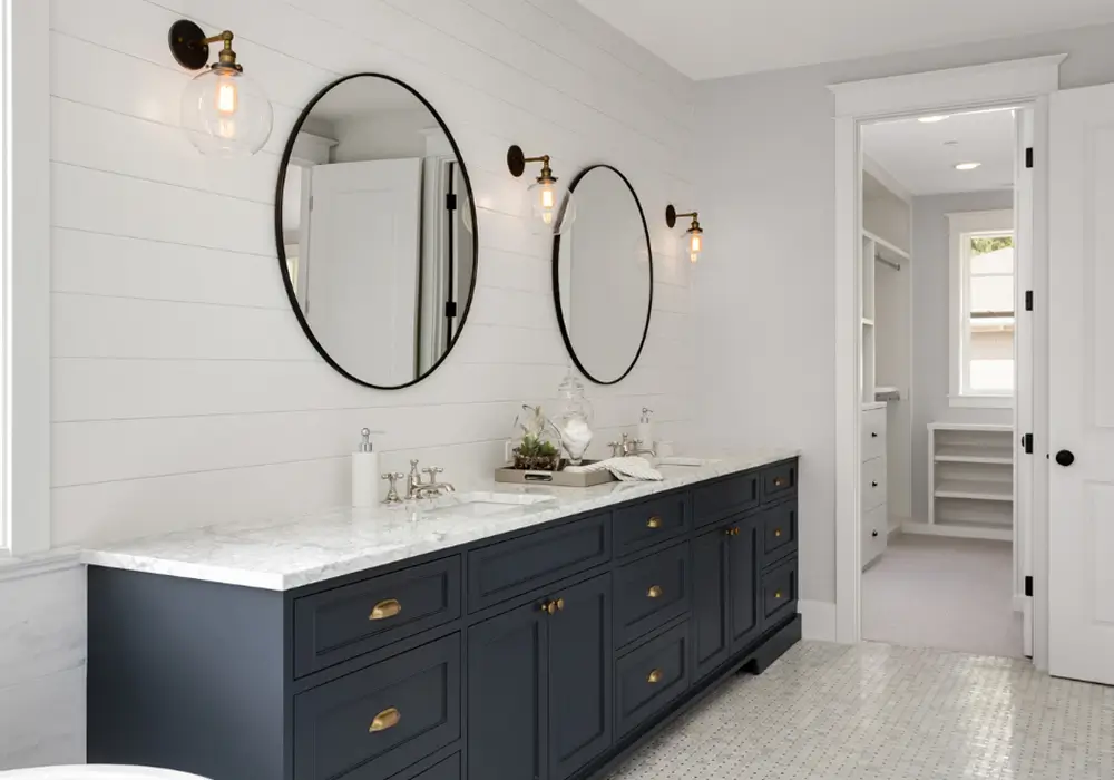 modern-bathroom-blue-cabinets-black-rounded-mirrors