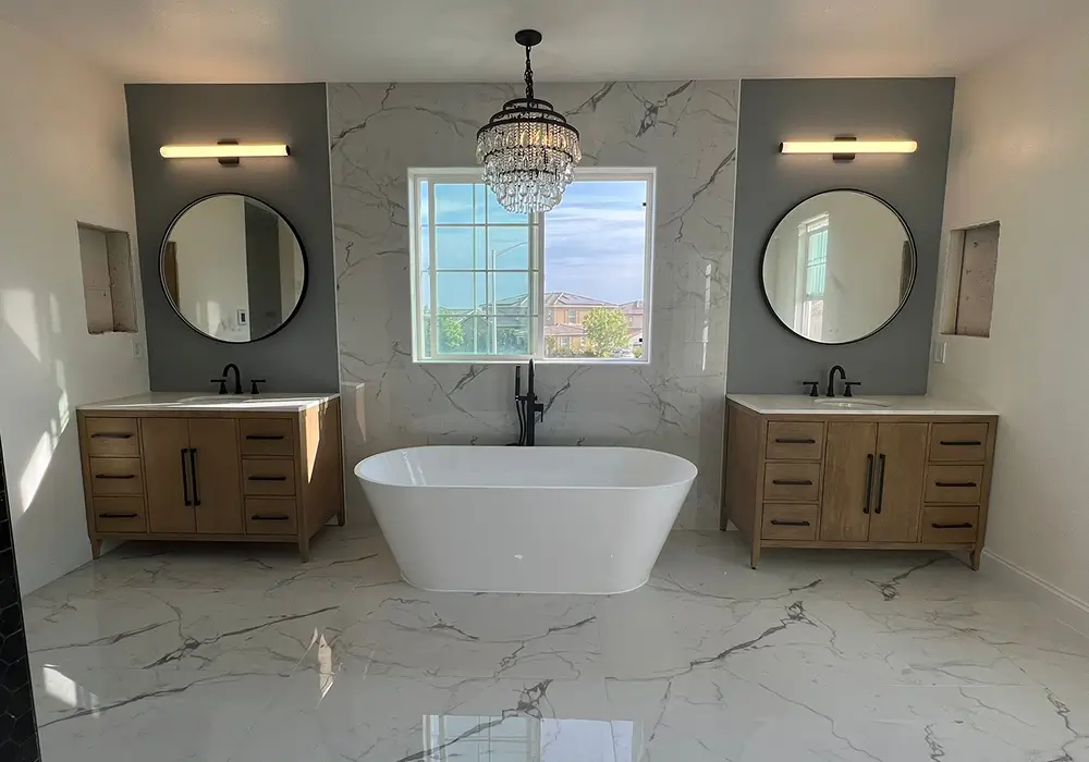 modern-bathroom-marble-floor-floating-cabinets-rounded-mirros-tub-in-the-middle